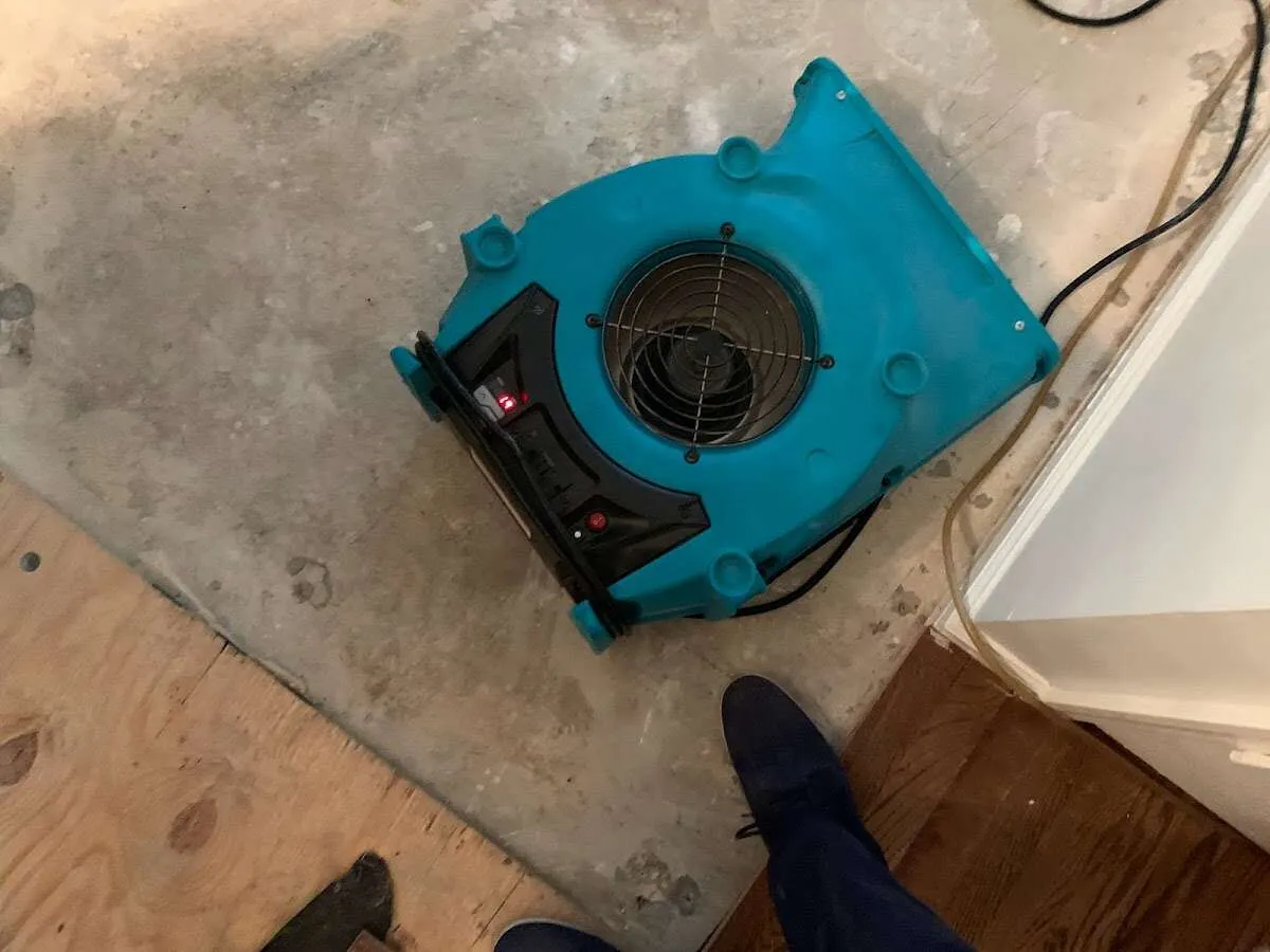 Air mover drying subfloor during Leak Detection & Repair in Salem Lakes